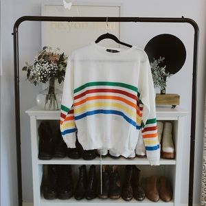White sweater with rainbow stripes